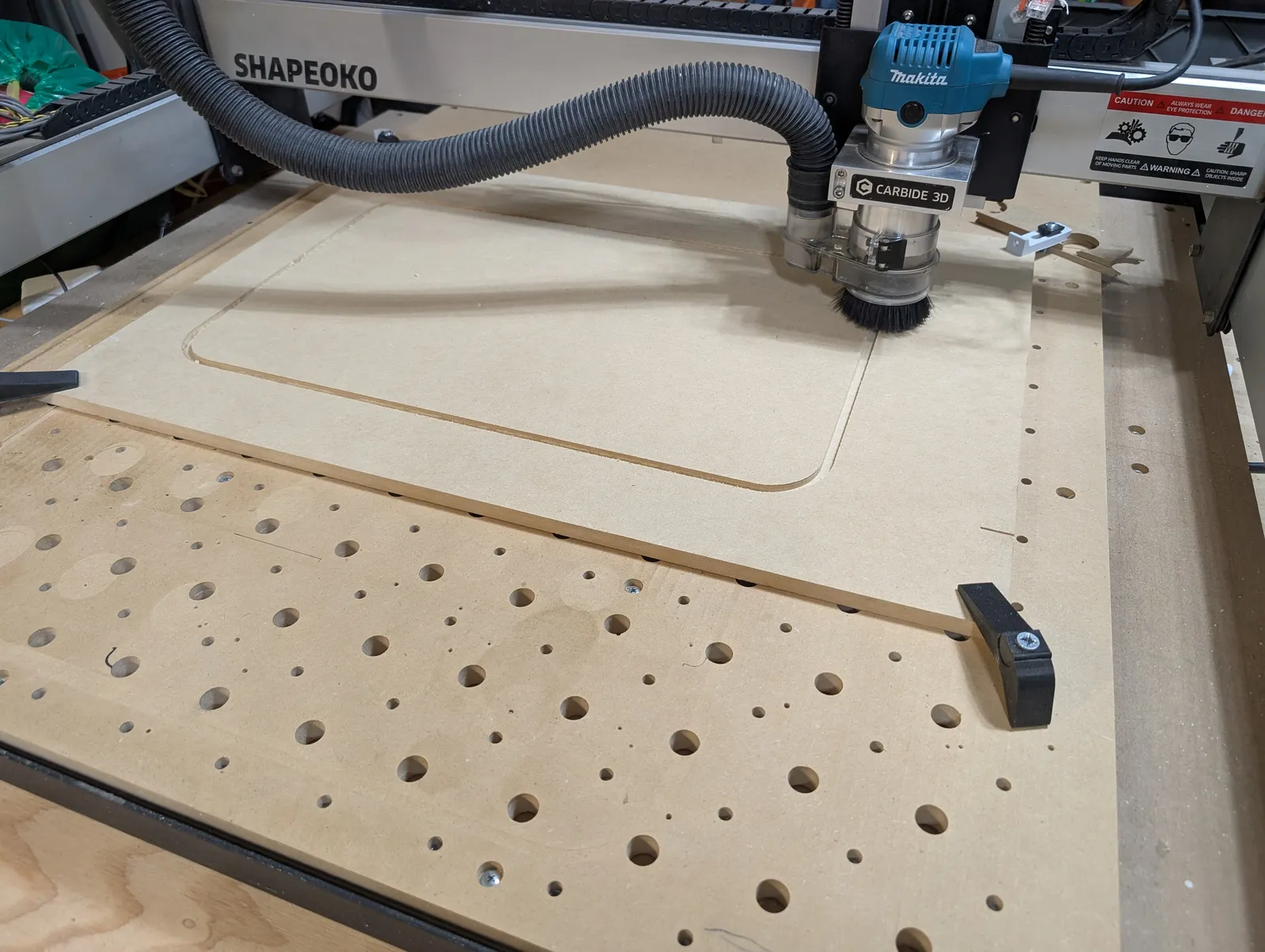 Shapeoko CNC router cutting the wood backing for Micromanaging